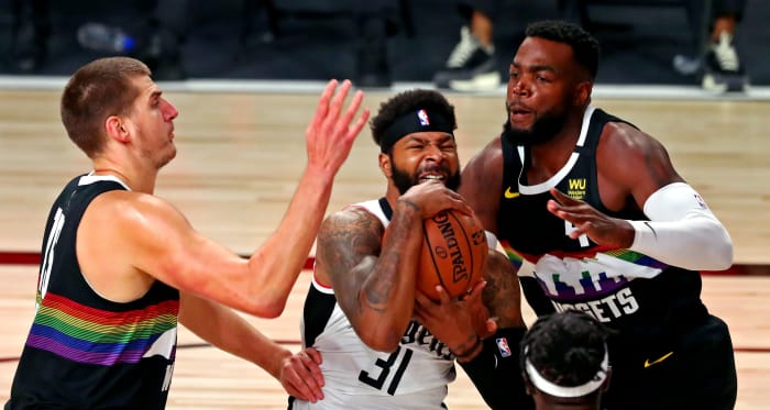 LA Clippers forward Marcus Morris Sr. (31) drives to the basket against Denver Nuggets forward Paul Millsap (4) during the first quarter in game six of the second round of the 2020 NBA Playoffs